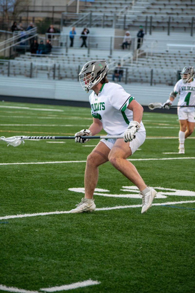 Senior defenseman Dylan Minnick sets himself up for the opposing offensive push. Minnick has been a leader for the Wildcats team all season.
