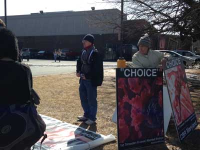 Darnel-and-Kenny-stood-on-the-border-of-WJ-and-Georgetown-Square-with-anti-abortion-posters.
